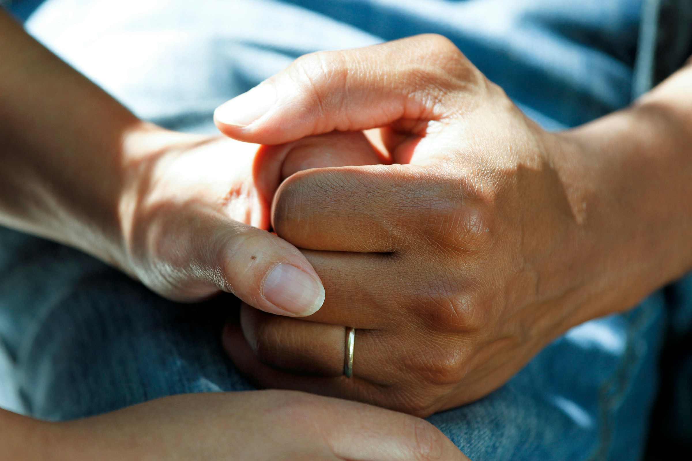 Two people holding hands, a moment of care and comfort